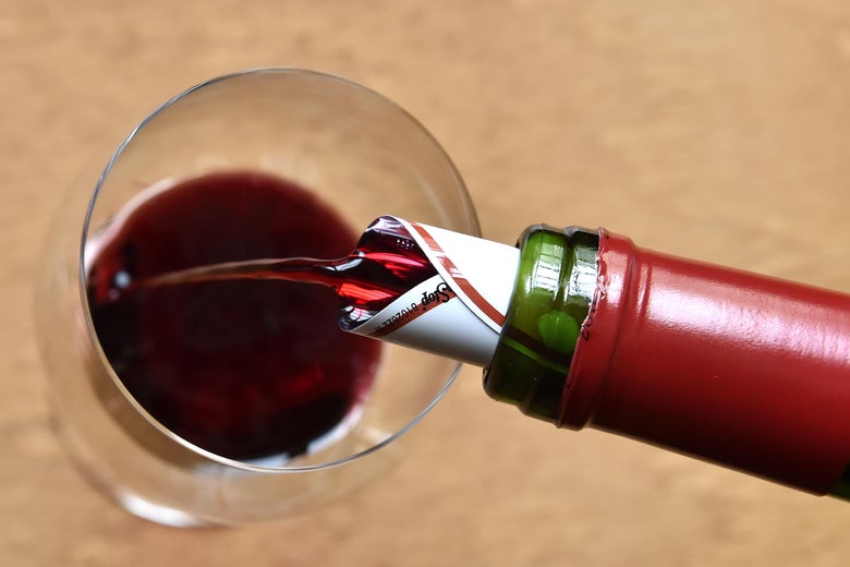 Red wine is served in a glass during a wine tasting session at the Etablissements Jean-Pierre Moueix wine merchant in Libourne, on April 10, 2018.